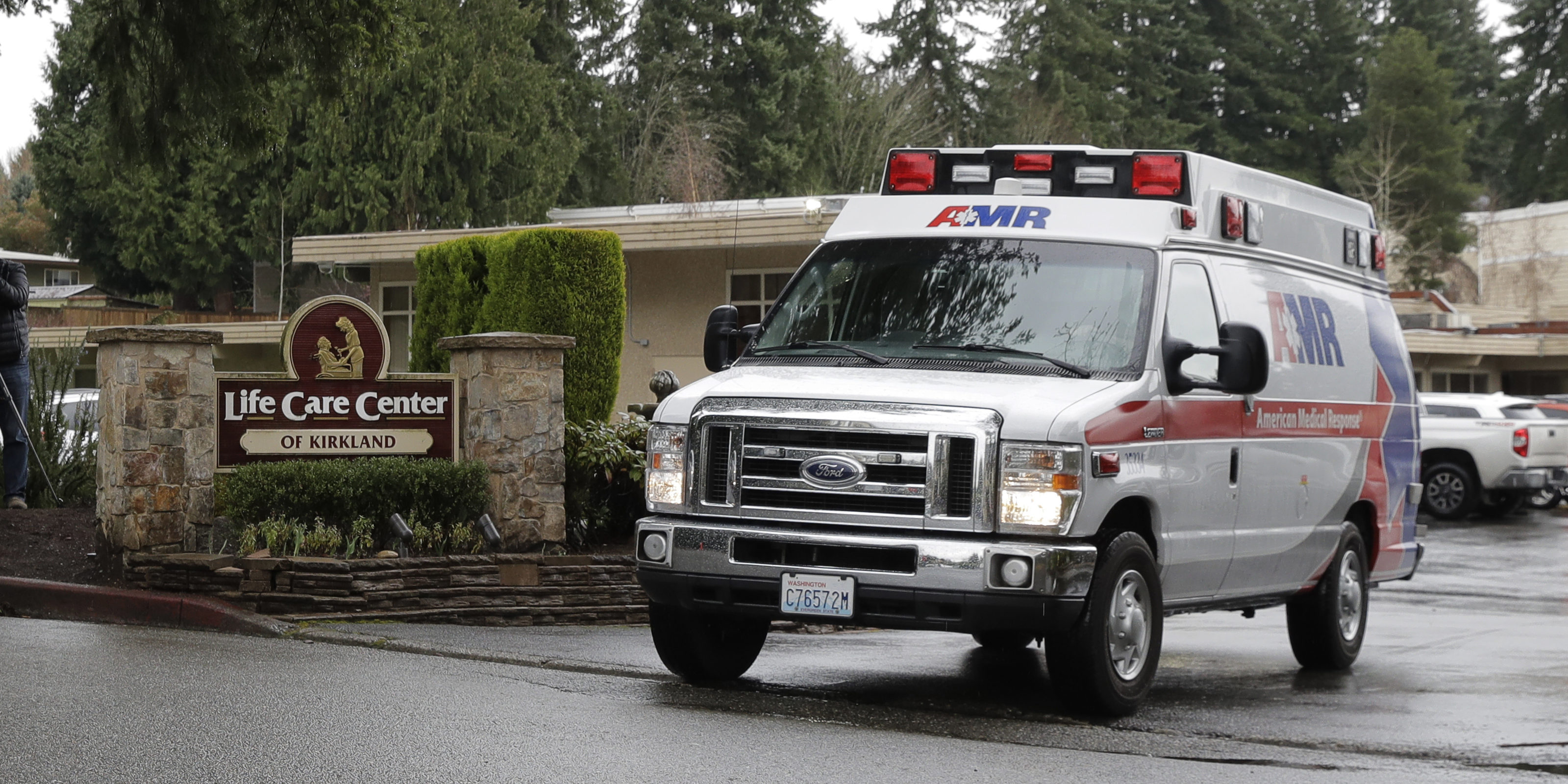 An ambulance leaves the Life Care Center in Kirkland, Wash., Friday, March 6, 2020. The facility is the epicenter of the outbreak of the the COVID-19 coronavirus in Washington state. (AP Photo/Ted S. Warren)
